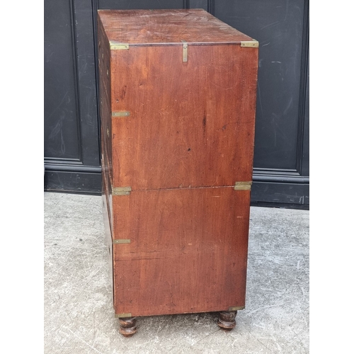1022 - A late Victorian teak and brass bound campaign chest, in two parts, with countersunk handles, 106.5c... 