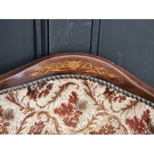1063 - An Edwardian mahogany and inlaid tub chair.