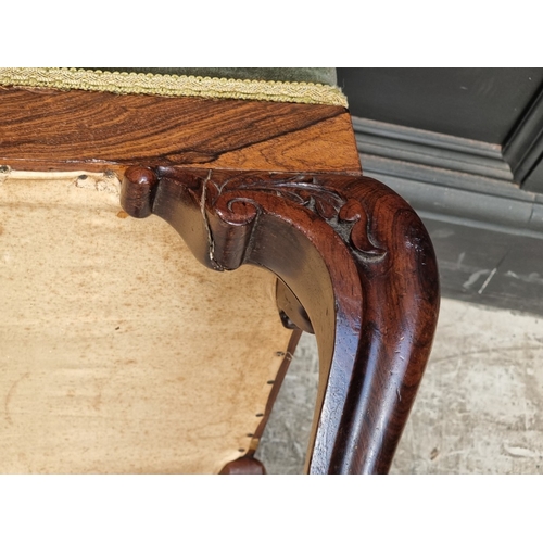 1069 - A Victorian carved rosewood and upholstered long stool, 110cm wide.