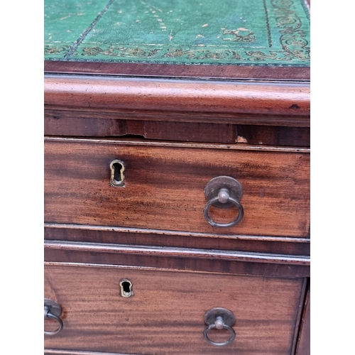 1071 - A 19th century mahogany pedestal desk, of free standing form, with dummy drawers and cupboards to th... 