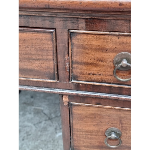 1071 - A 19th century mahogany pedestal desk, of free standing form, with dummy drawers and cupboards to th... 