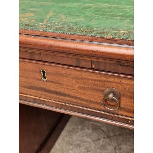 1071 - A 19th century mahogany pedestal desk, of free standing form, with dummy drawers and cupboards to th... 