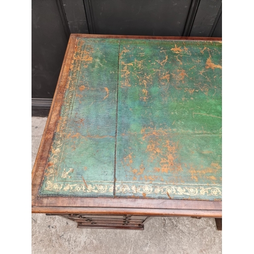 1071 - A 19th century mahogany pedestal desk, of free standing form, with dummy drawers and cupboards to th... 