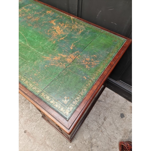 1071 - A 19th century mahogany pedestal desk, of free standing form, with dummy drawers and cupboards to th... 