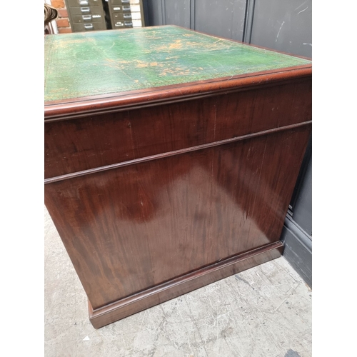 1071 - A 19th century mahogany pedestal desk, of free standing form, with dummy drawers and cupboards to th... 