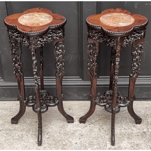 1080 - A good pair of 19th century Chinese carved and pierced hardwood stands, the quatrefoil tops with mar... 