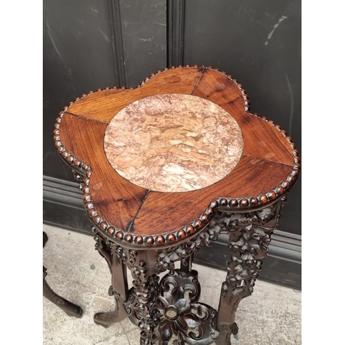 1080 - A good pair of 19th century Chinese carved and pierced hardwood stands, the quatrefoil tops with mar... 