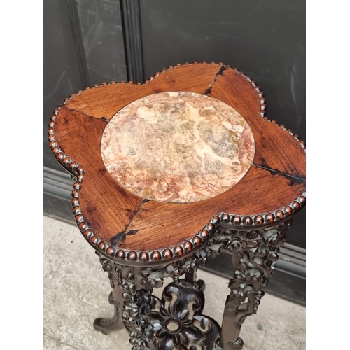 1080 - A good pair of 19th century Chinese carved and pierced hardwood stands, the quatrefoil tops with mar... 