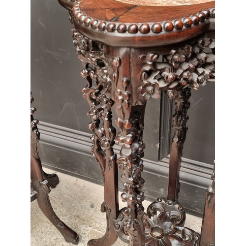 1080 - A good pair of 19th century Chinese carved and pierced hardwood stands, the quatrefoil tops with mar... 
