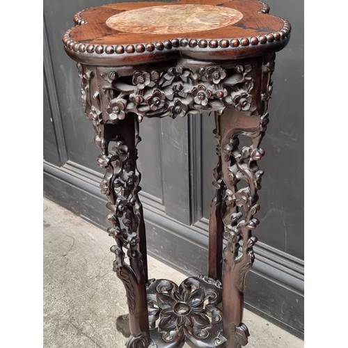 1080 - A good pair of 19th century Chinese carved and pierced hardwood stands, the quatrefoil tops with mar... 