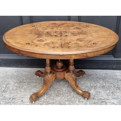 1082 - A Victorian figured walnut and inlaid oval tilt-top loo table, 118cm wide.