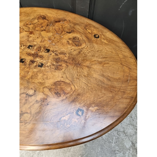 1082 - A Victorian figured walnut and inlaid oval tilt-top loo table, 118cm wide.