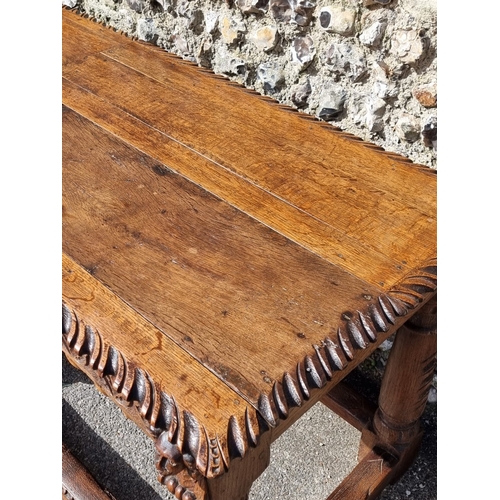 1089 - An antique carved oak refectory type table, the top 210 x 73cm, (reconstructed from old elements).... 