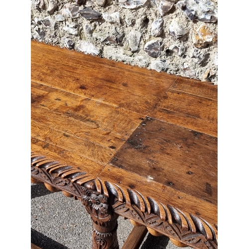 1089 - An antique carved oak refectory type table, the top 210 x 73cm, (reconstructed from old elements).... 