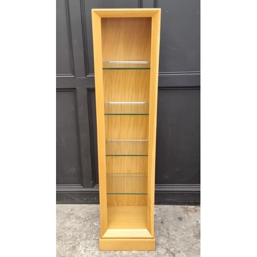 1094 - A contemporary pale oak open bookcase, with four glass shelves, 184cm high x 42cm wide x 37cm deep.... 