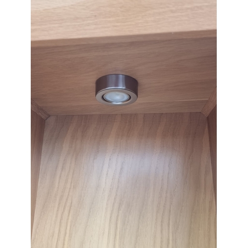 1094 - A contemporary pale oak open bookcase, with four glass shelves, 184cm high x 42cm wide x 37cm deep.... 