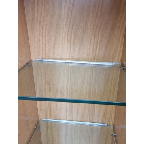 1094 - A contemporary pale oak open bookcase, with four glass shelves, 184cm high x 42cm wide x 37cm deep.... 