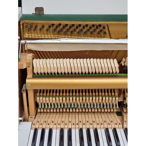 1098 - A small Kemble upright piano, 113.5cm wide; together with a matching stool. (2)