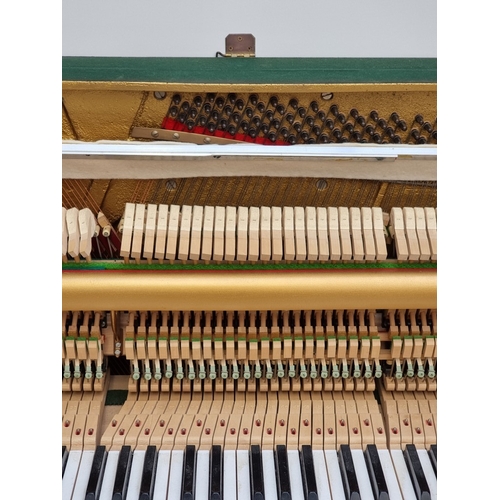 1098 - A small Kemble upright piano, 113.5cm wide; together with a matching stool. (2)