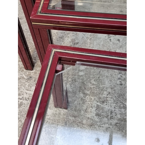 1118 - A nest of three Pierre Vandel occasional tables, each with bevelled glass inset, (smallest chipped),... 