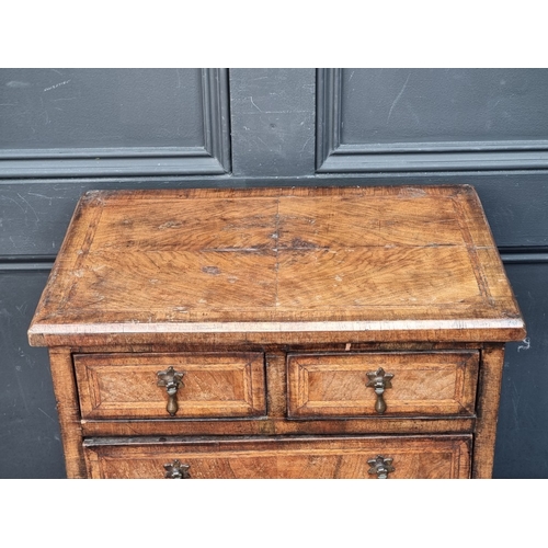 1134 - Miniature Furniture: an 18th century style walnut and feather banded chest of drawers, 50cm high x 4... 