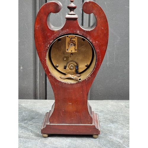 1178 - An Art Nouveau mahogany and inlaid mantel timepiece, 28cm high.