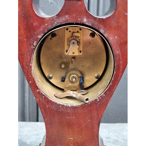 1178 - An Art Nouveau mahogany and inlaid mantel timepiece, 28cm high.