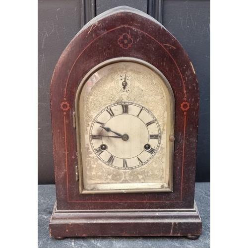 1181 - A late 19th century mahogany and inlaid lancet form mantel clock, with silvered dial, striking on fo... 