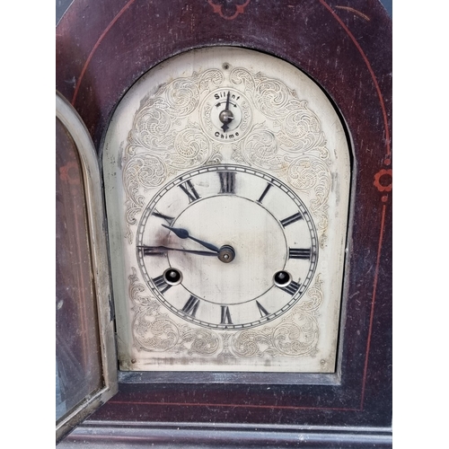1181 - A late 19th century mahogany and inlaid lancet form mantel clock, with silvered dial, striking on fo... 