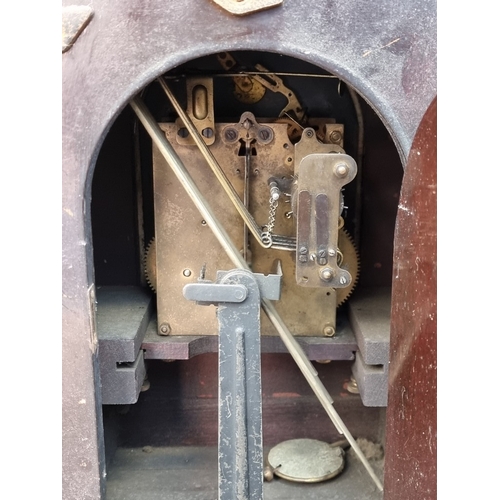 1181 - A late 19th century mahogany and inlaid lancet form mantel clock, with silvered dial, striking on fo... 