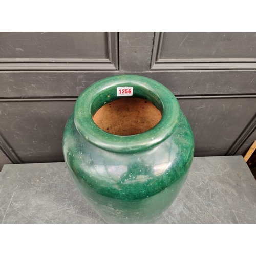 1256 - A large green glazed terracotta vase, 60cm high, (drilled to base).