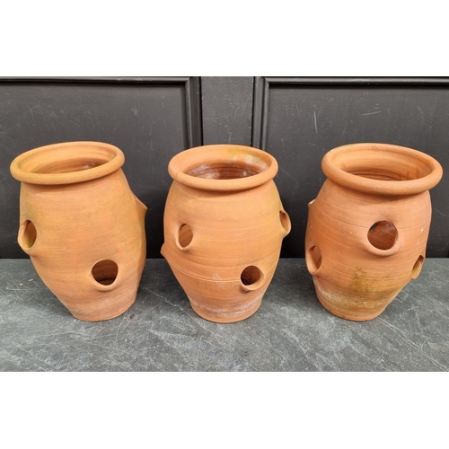 1302 - A set of three terracotta strawberry pots, 28.5cm high.