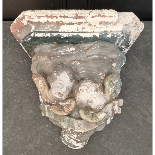 1308 - A large painted plaster cherub wall bracket, 44 x 48.5cm, (s.d.).