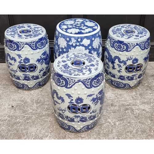 1310 - A set of three Chinese blue and white barrel form garden seats, 43cm high; together with another sli... 