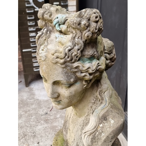 1311 - A life-sized composition stone female bust, on associated pedestal, 102.5cm high.