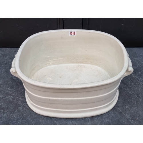 1312 - A Victorian Creamware twin handled footbath, 47cm wide, (star cracks to base).