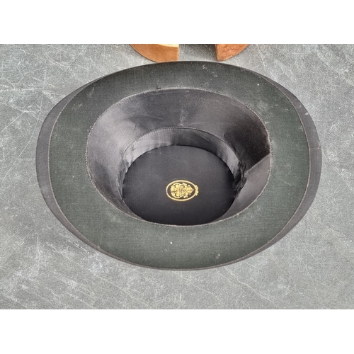 1327 - A vintage beech hat stretcher, 30cm high; together with an opera hat. (2)