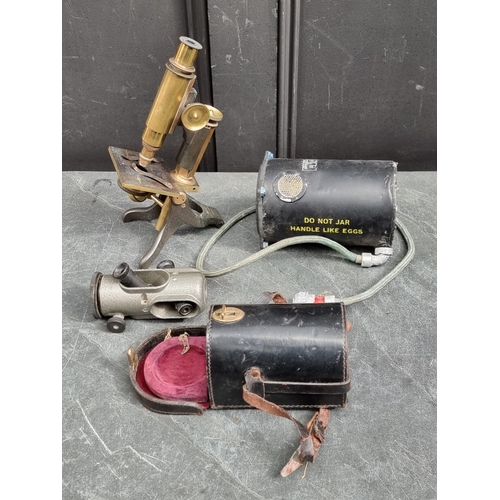 1338 - A vintage brass microscope; together with an artificial Horizon Mk.3C; and another cased instrument.... 
