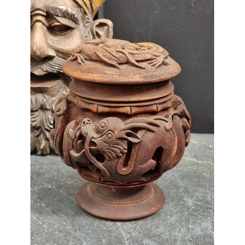 1347 - An Eastern carved wood cup and cover, decorated with dragons, 16.5cm high; together with an Indian c... 