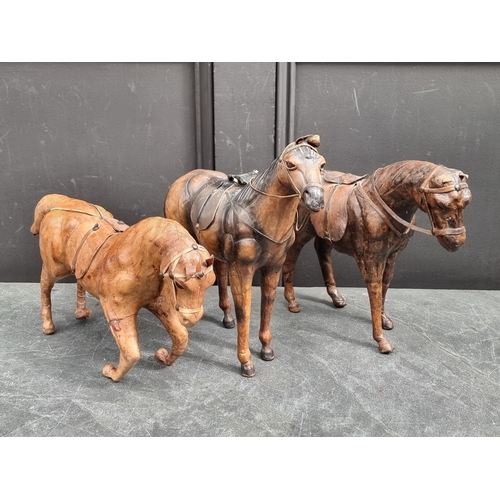 1351 - Three leather horses, largest 32cm high.