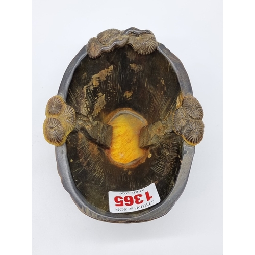 1365 - A Chinese carved horn libation cup, four character seal mark to base, 12.5cm wide.