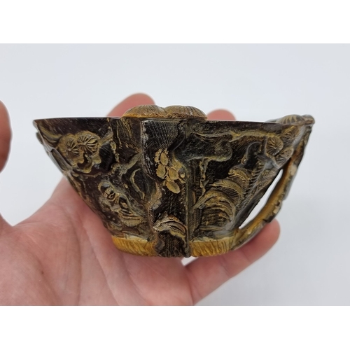 1365 - A Chinese carved horn libation cup, four character seal mark to base, 12.5cm wide.
