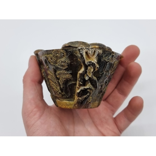 1365 - A Chinese carved horn libation cup, four character seal mark to base, 12.5cm wide.
