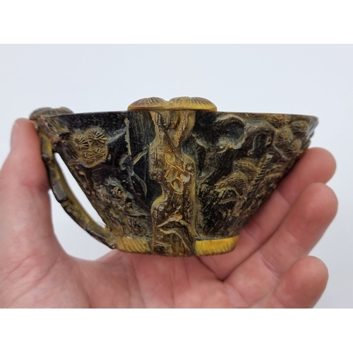 1365 - A Chinese carved horn libation cup, four character seal mark to base, 12.5cm wide.