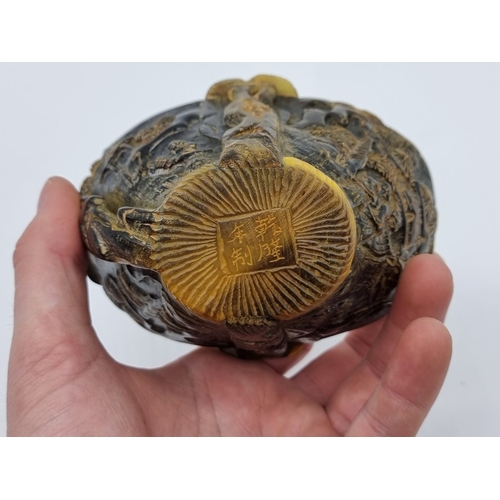 1365 - A Chinese carved horn libation cup, four character seal mark to base, 12.5cm wide.