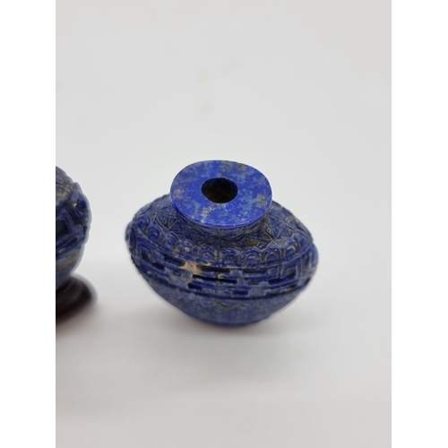 1368 - A pair of Chinese carved lapis lazuli snuff bottles, one with cover, total height 5.2cm, with one ha... 