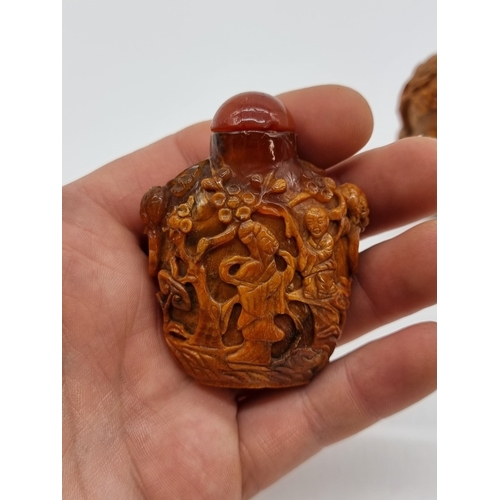 1369 - Two Chinese carved amber snuff bottles and hardstone covers, probably Qing, total height of largest ... 