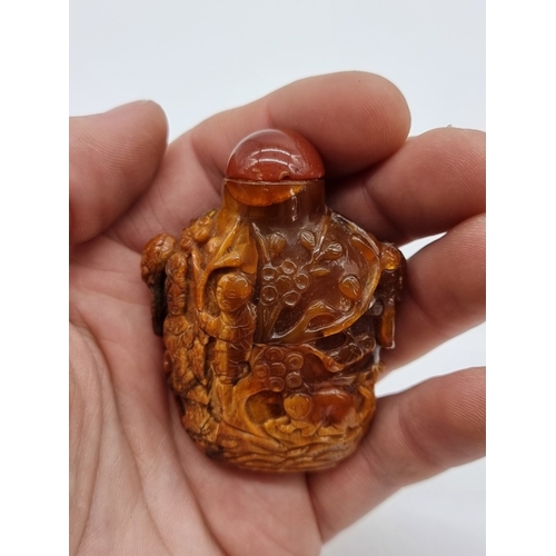 1369 - Two Chinese carved amber snuff bottles and hardstone covers, probably Qing, total height of largest ... 
