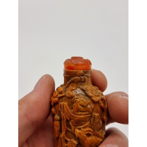 1369 - Two Chinese carved amber snuff bottles and hardstone covers, probably Qing, total height of largest ... 