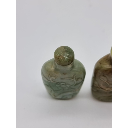 1372 - Two Chinese carved jade snuff bottles and stoppers, Qing, total height of largest 7cm. (2)... 